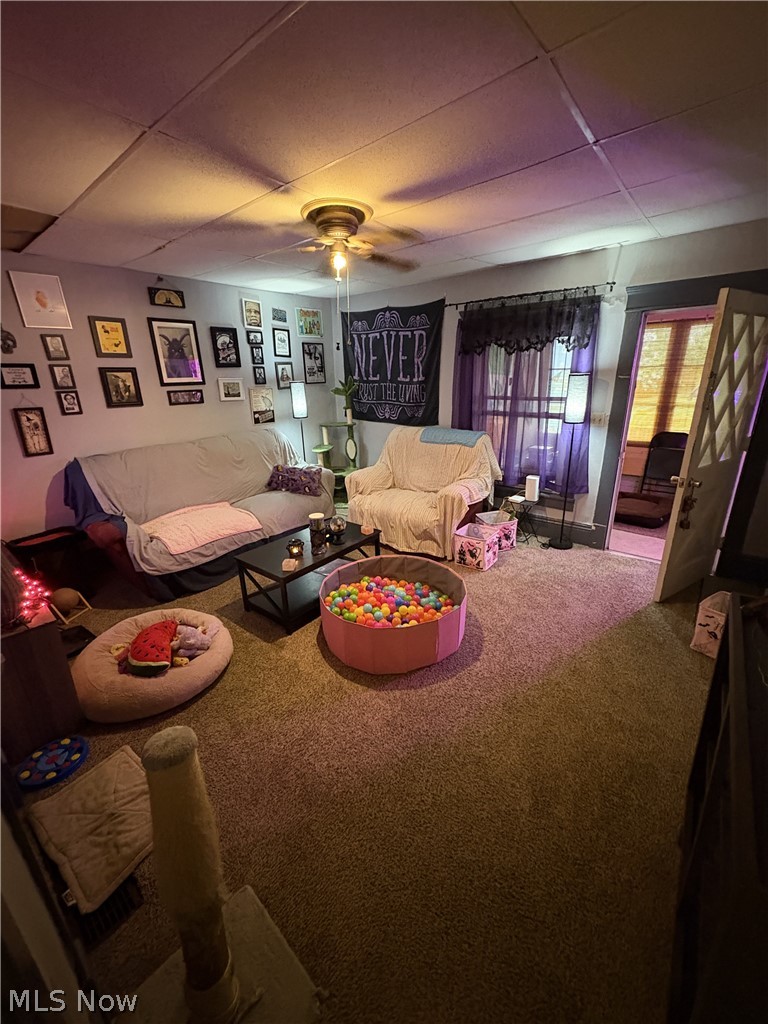 727 Wooster Road North Barberton, OH 44203 - Photo 22 of 37 729 (1-Bed) - Carpeted livingroom featuring a ceiling fan with integrated lighting, a panelized ceiling, and door to the sunroom