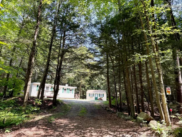 a view of house with a tree in front