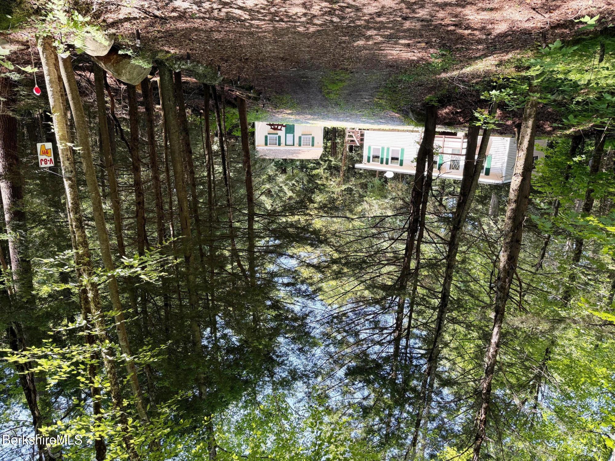 a view of house with a tree in front