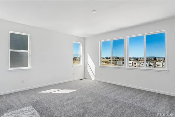 a view of an empty room with window and cabinet