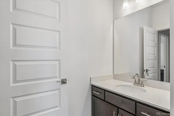 a bathroom with a sink vanity and mirror