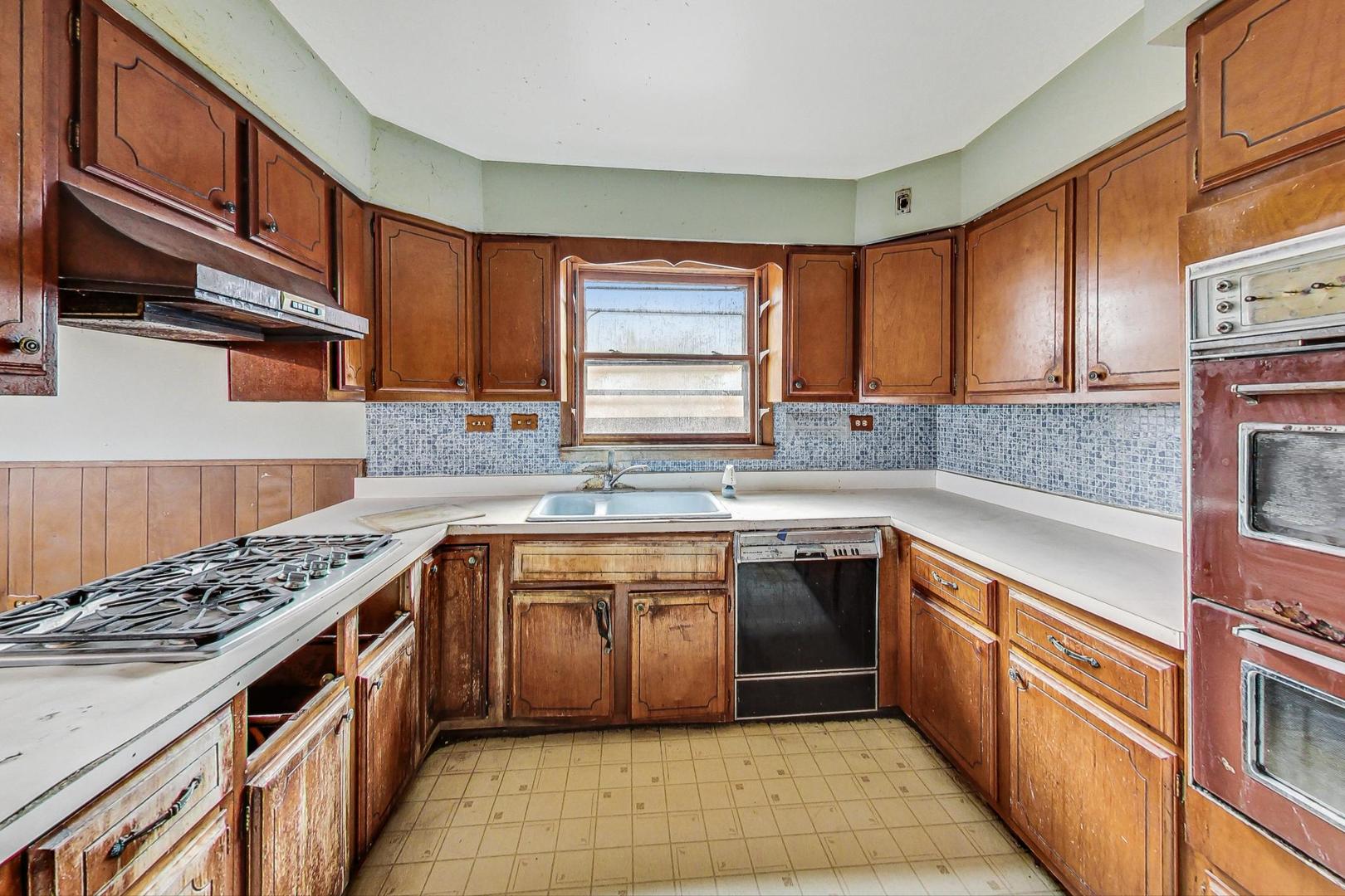 771 Ridge Road Highland Park, IL 60035 - Photo 13 of 54 a kitchen with stainless steel appliances granite countertop a sink stove and cabinets