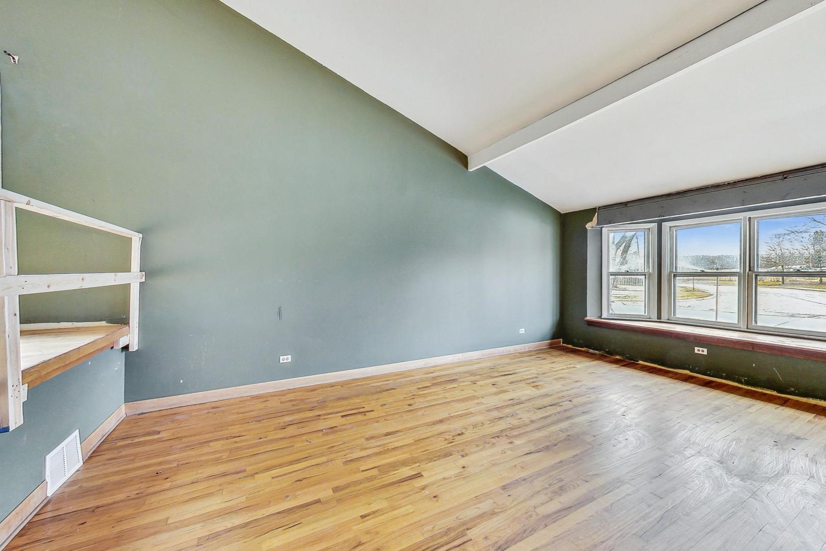771 Ridge Road Highland Park, IL 60035 - Photo 8 of 54 a view of an empty room with a window and wooden floor