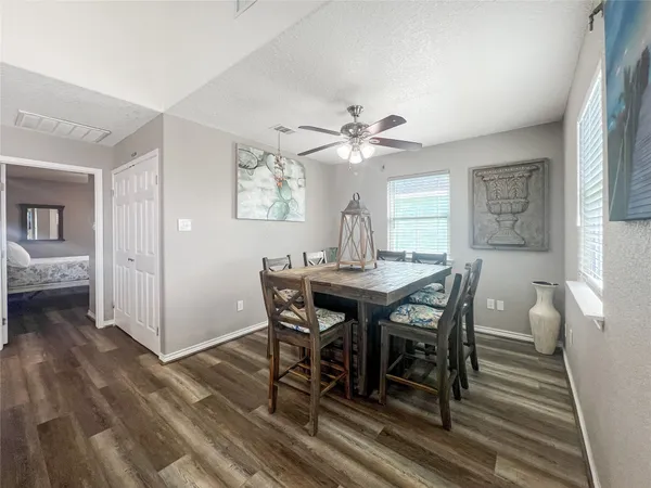 a view of a dining room with furniture and wooden floor