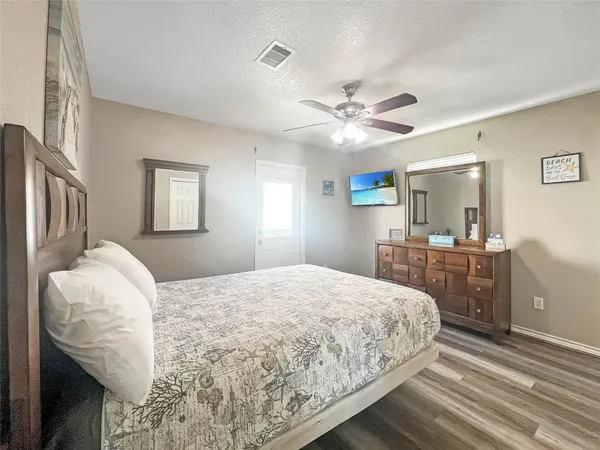 a bedroom with a bed dresser and a window