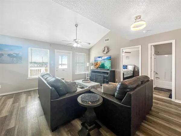 a living room with furniture and a wooden floor