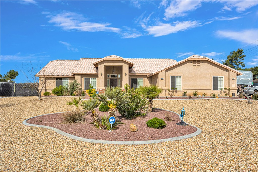 15648 Atnah Road Apple Valley, CA 92307 - Photo 1 of 1 a front view of a house with a yard