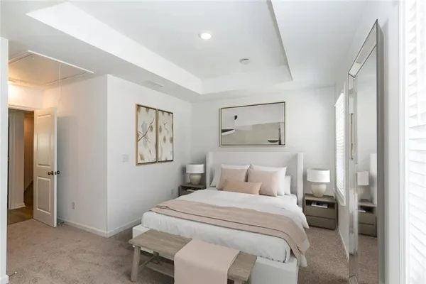 a bedroom with a bed and a painting