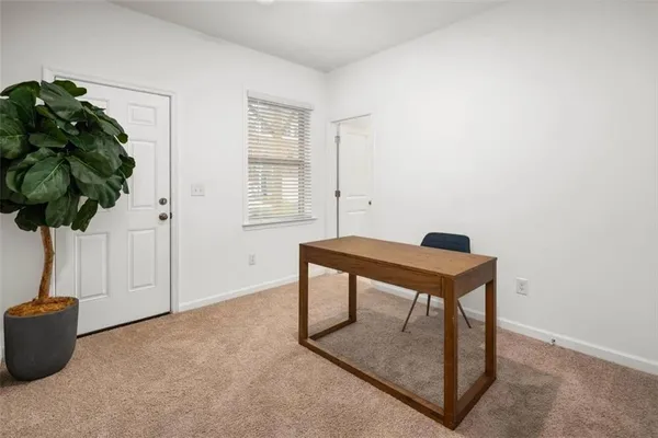 a room with a table and a potted plant