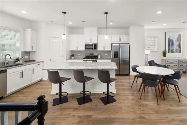 a large kitchen with a table and chairs