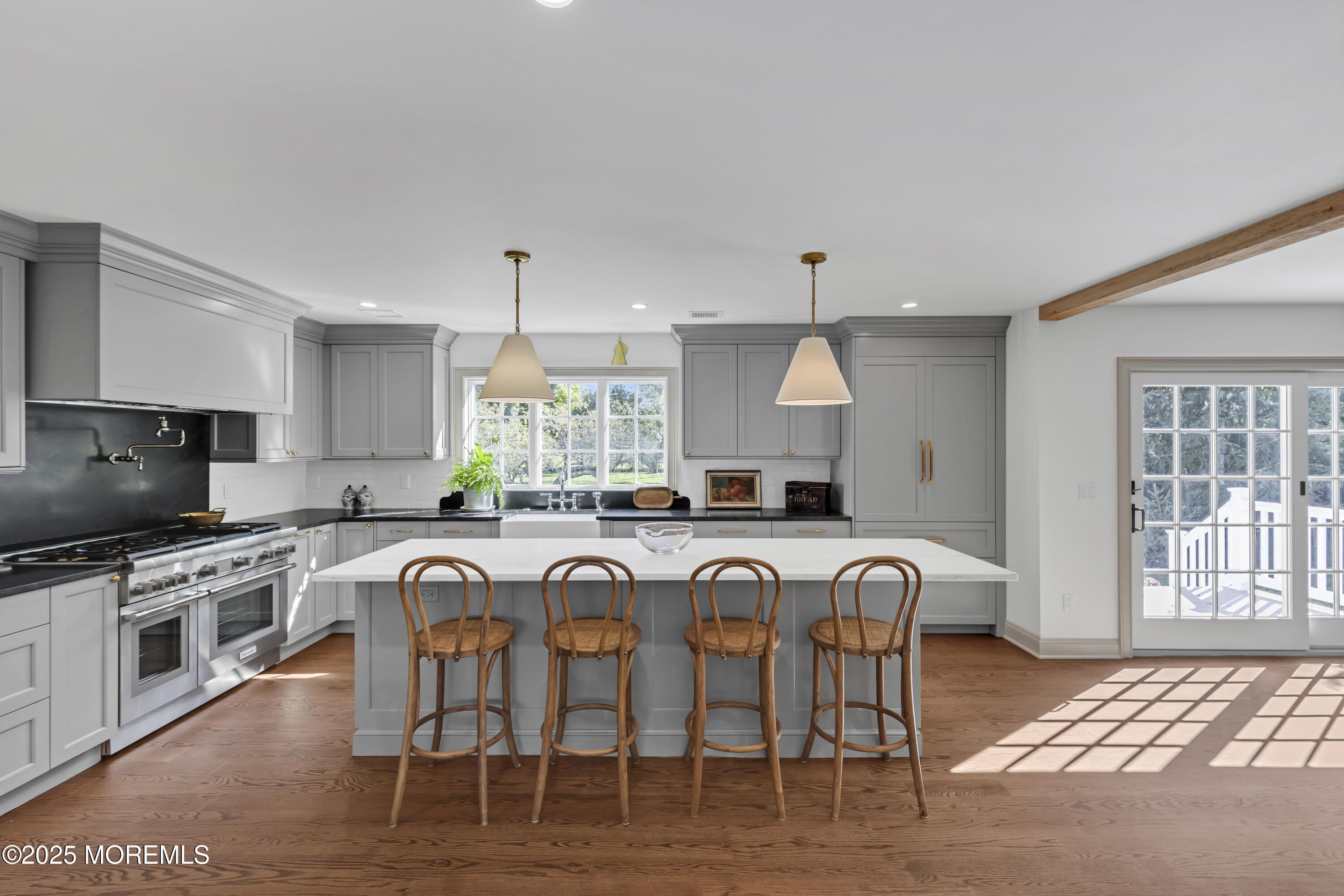 420 Rumson Road Little Silver, NJ 07739 - Photo 14 of 51 a kitchen with stainless steel appliances granite countertop a stove top oven a sink a dining table and chairs