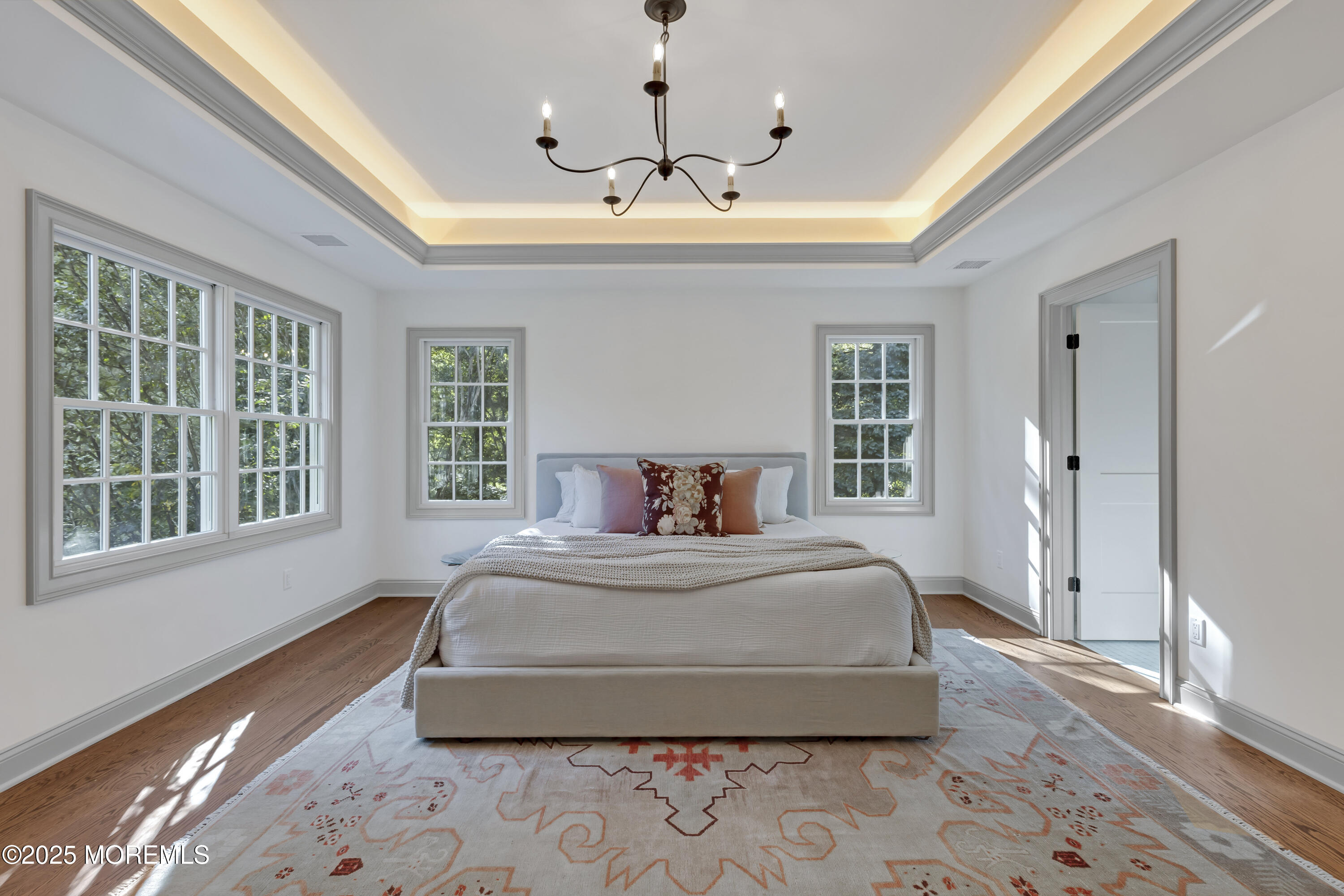 420 Rumson Road Little Silver, NJ 07739 - Photo 27 of 51 a spacious bedroom with a bed and a chandelier