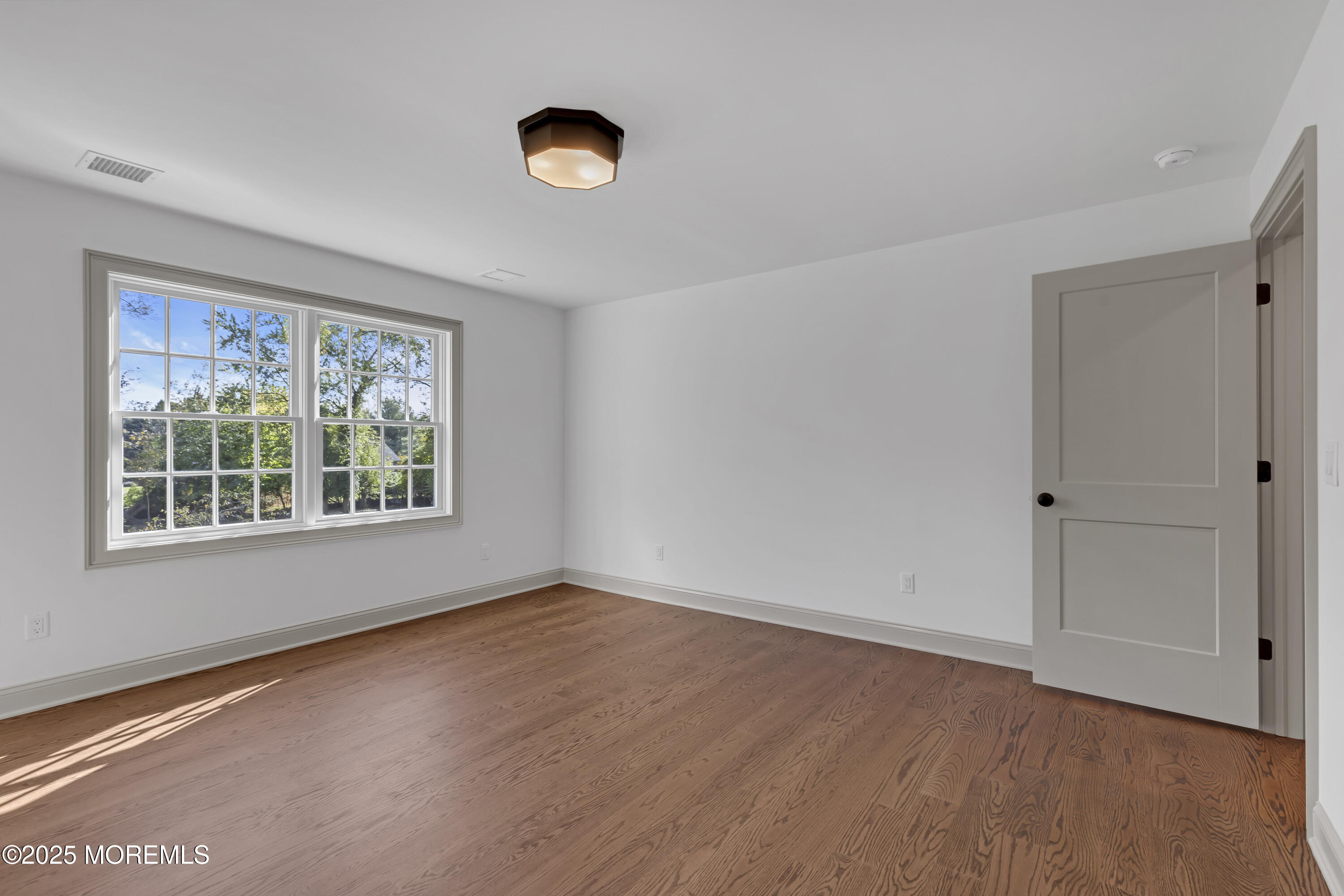 420 Rumson Road Little Silver, NJ 07739 - Photo 28 of 51 a view of an empty room with wooden floor and a window