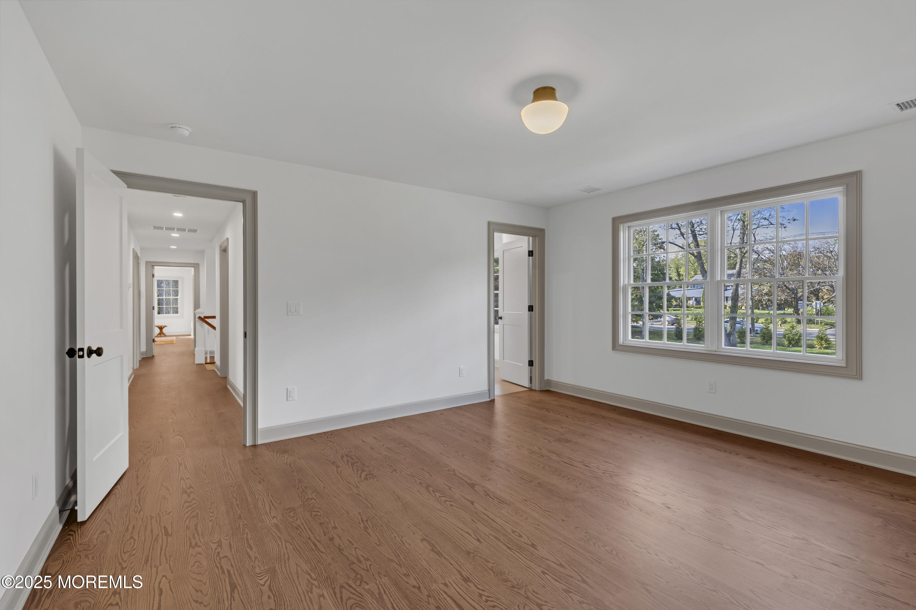 420 Rumson Road Little Silver, NJ 07739 - Photo 29 of 51 a view of an empty room with a window and wooden floor
