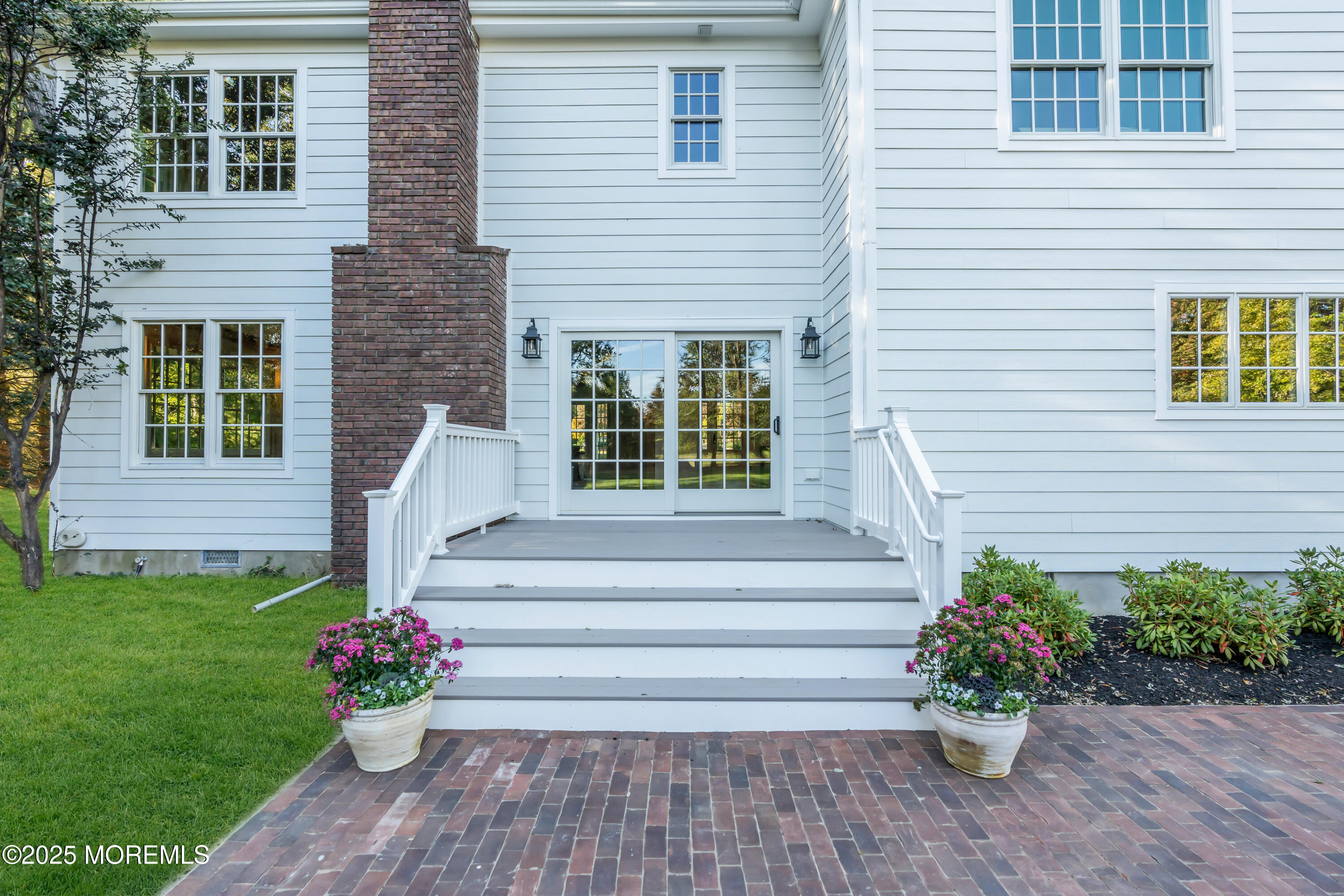 420 Rumson Road Little Silver, NJ 07739 - Photo 47 of 51 a front view of a house with a garden and flowers
