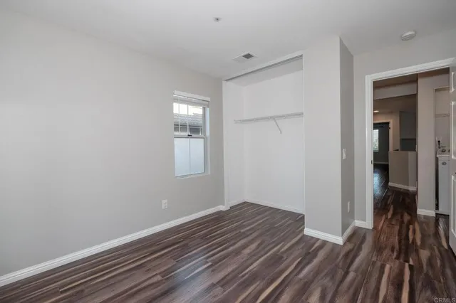a view of a room with wooden floor