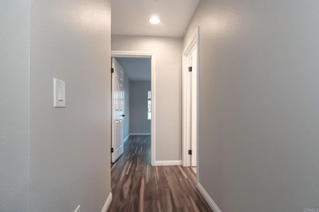 a view of hallway with wooden floor