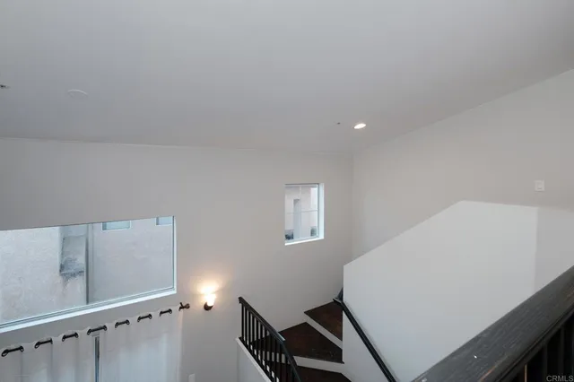 a view of room with stairs and wooden floor