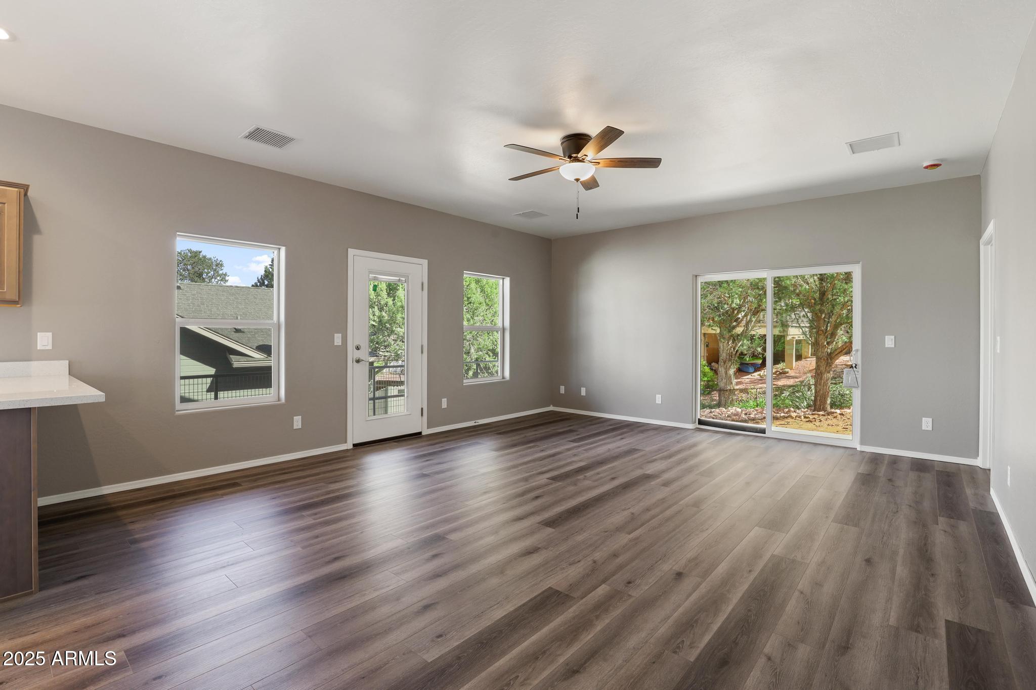 1019 South Ponderosa Street Payson, AZ 85541 - Photo 2 of 34 a view of an empty room with a window and wooden floor