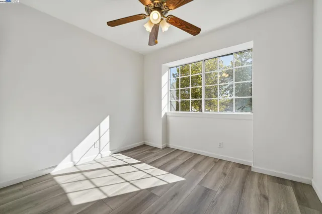 a view of room with window and wooden floor