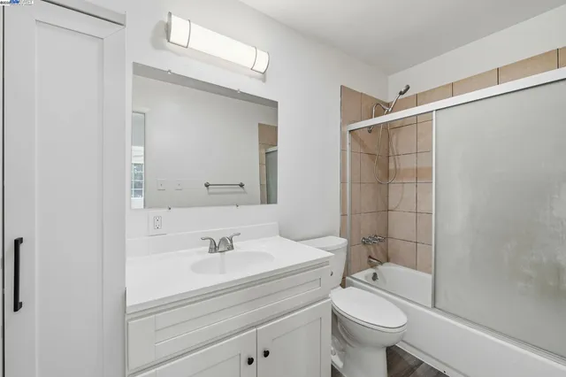 a view of backyard with large windows and plants