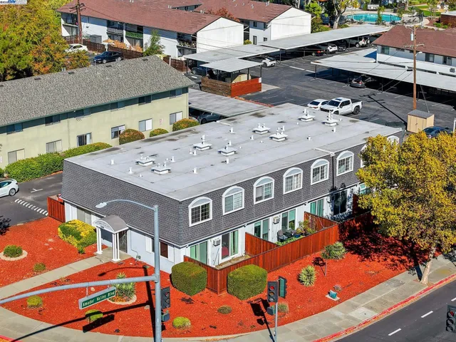 an aerial view of residential houses with outdoor space