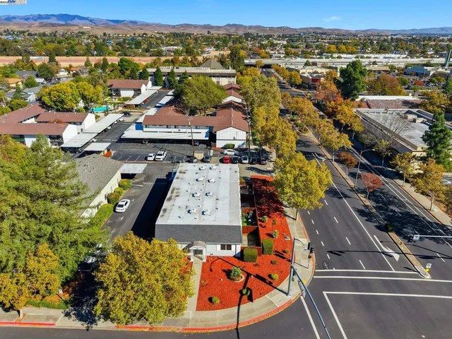 an aerial view of residential houses with outdoor space