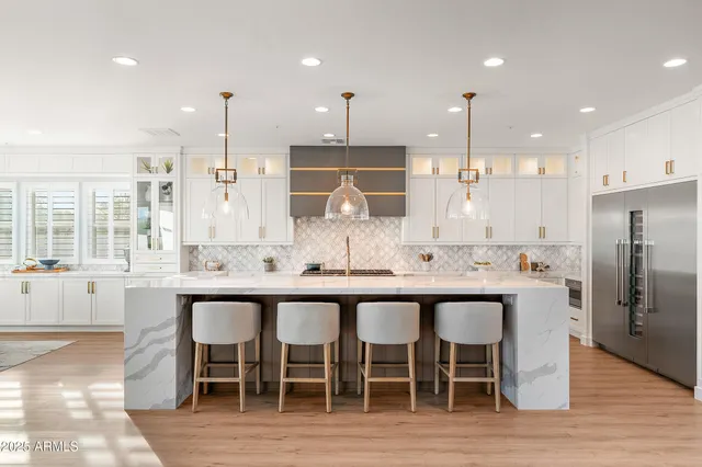 a large kitchen with stainless steel appliances kitchen island granite countertop a sink and cabinets