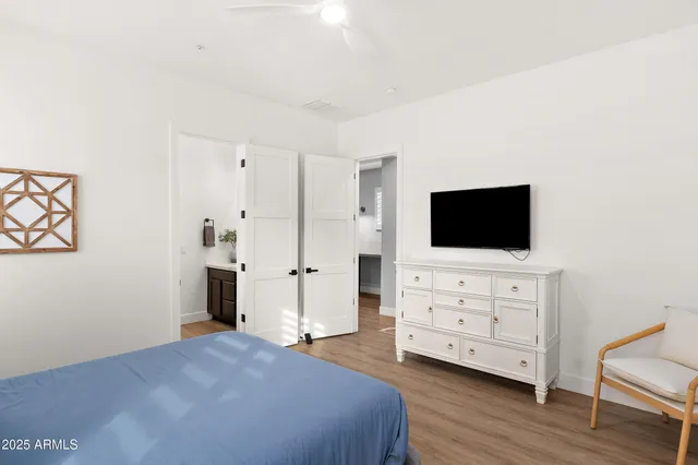 a bedroom with a bed and a flat screen tv