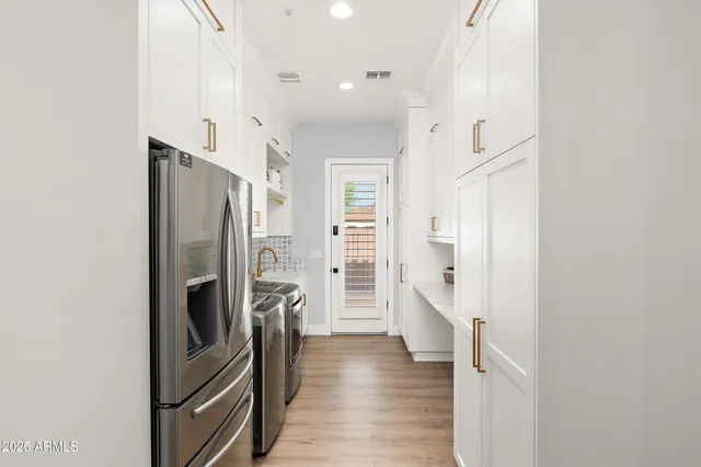 a view of an empty room with window and cabinet