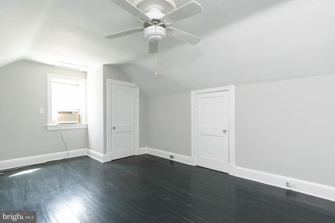 2418 Briarwood Road Baltimore, MD 21209 - Photo 29 of 55 an empty room with wooden floor fan and windows