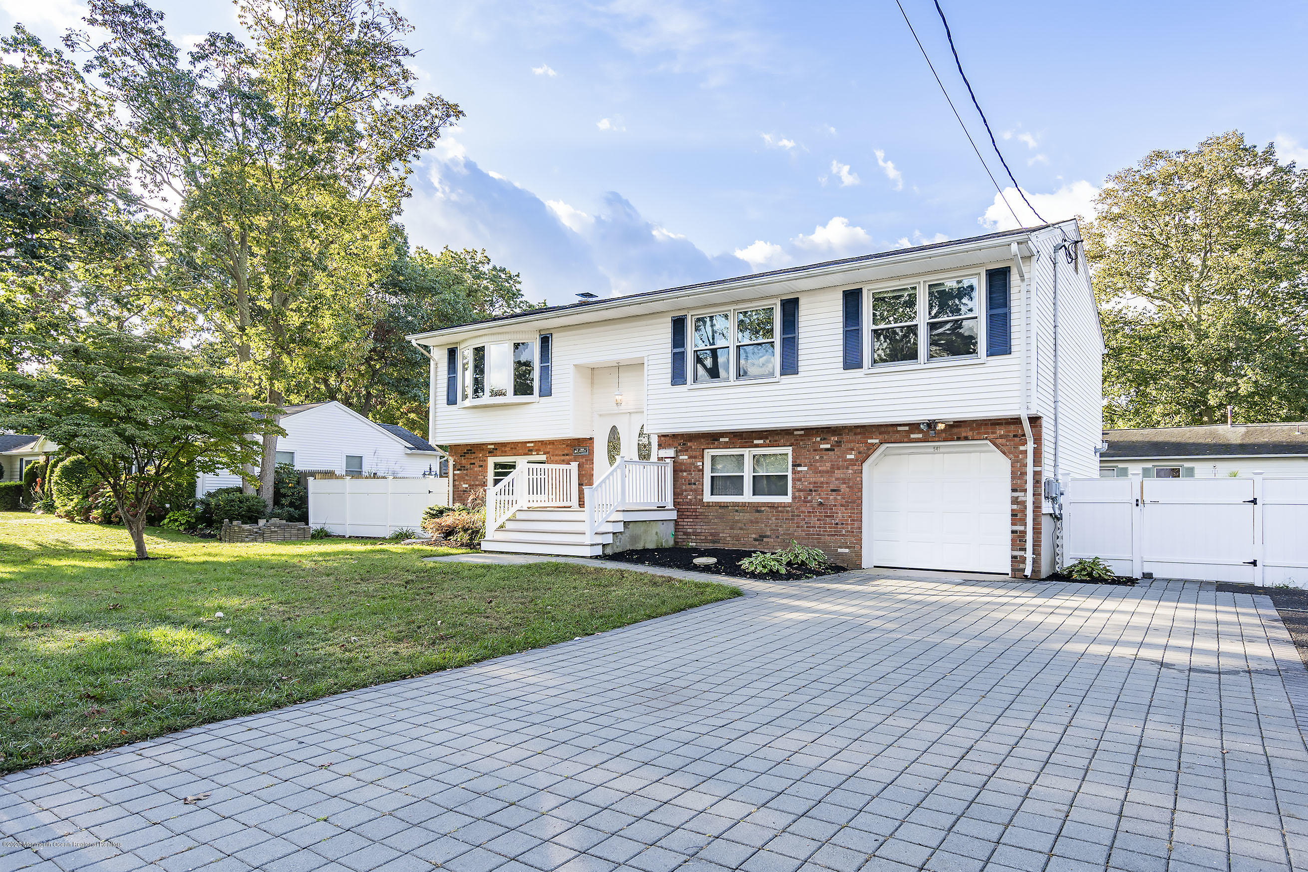 541 Nicholas Road Brick, NJ 08724 - Photo 3 of 40 a front view of a house with a yard and garage