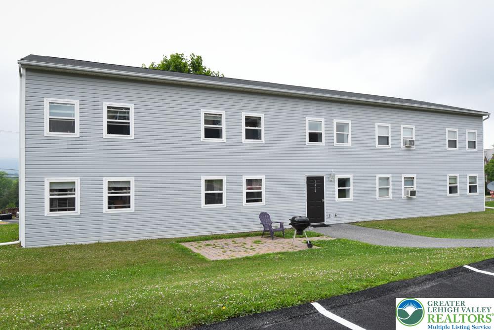 7404 Allemaengel Road, Unit 2 New Tripoli, PA 18066 - Photo 2 of 13 a front view of a house with a yard