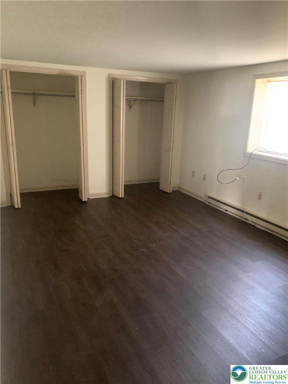 7404 Allemaengel Road, Unit 2 New Tripoli, PA 18066 - Photo 6 of 13 an empty room with wooden floor and windows
