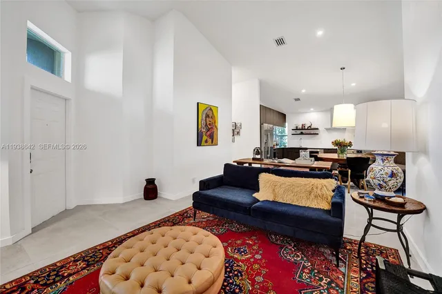 a kitchen with stainless steel appliances a refrigerator a sink a stove and cabinets