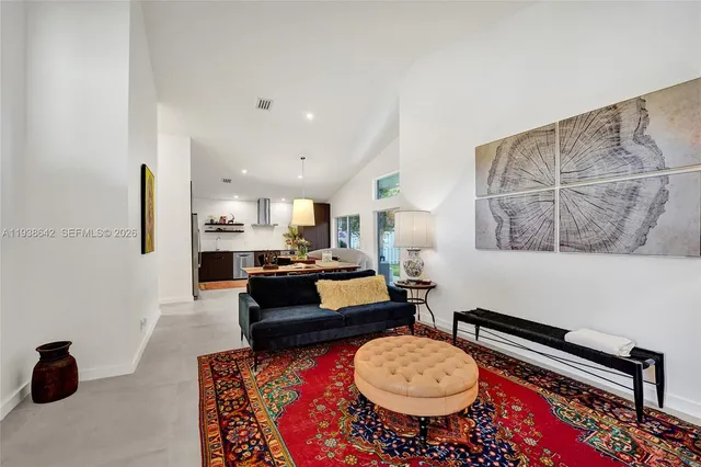 a bedroom with a bed and painting on the wall