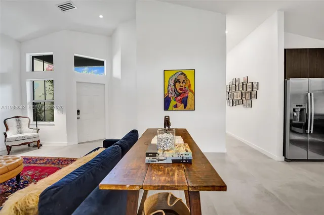 a bedroom with a bed and a wall painting