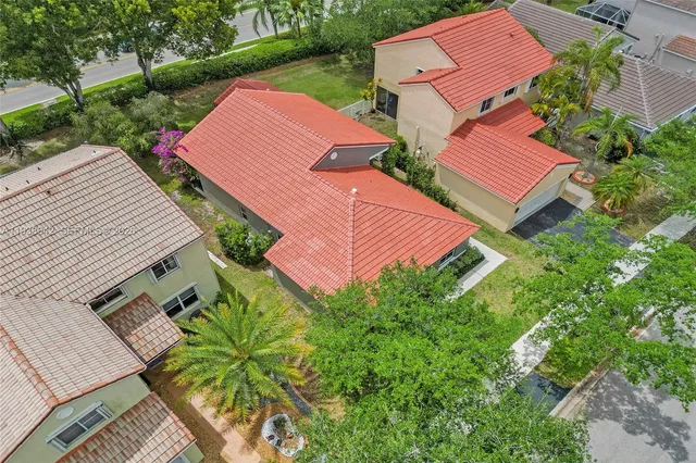 an aerial view of a house with a yard