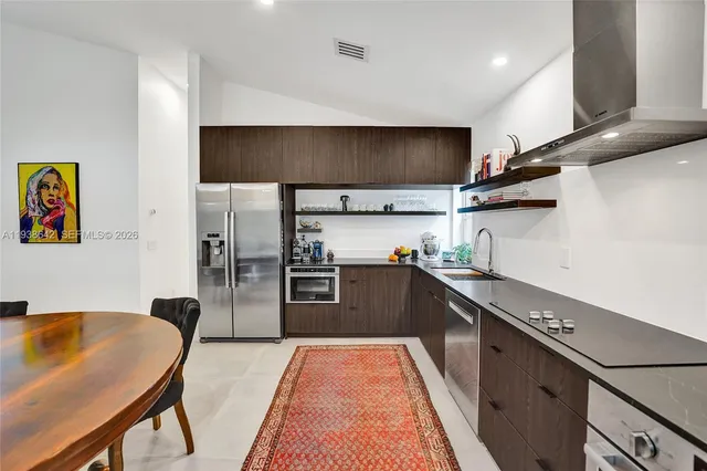 a bedroom with a bed a desk and chair with window