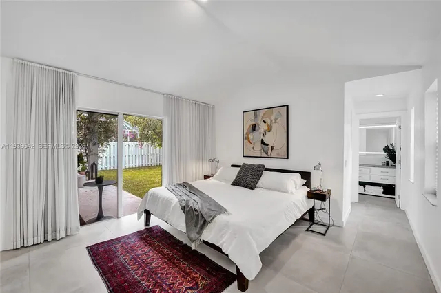 a living room with furniture a table and a floor to ceiling window