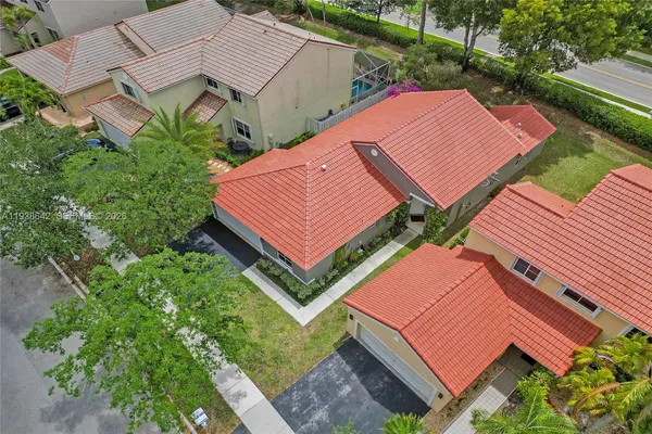 an aerial view of a house with a yard