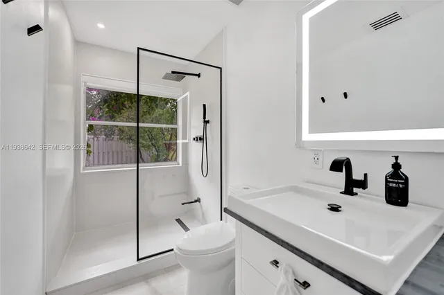 a view of a house with backyard sitting area and garden