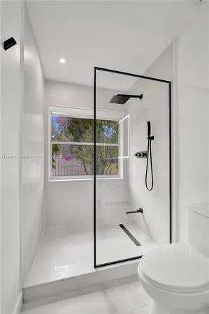 a pathway of a house with potted plants