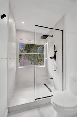a pathway of a house with potted plants