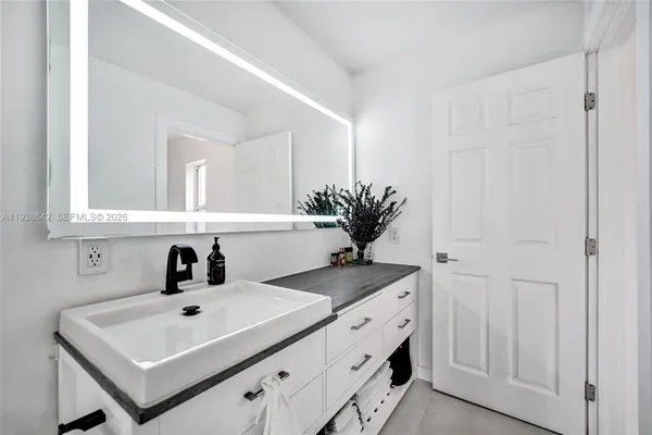 an aerial view of a house with a yard basket ball court and outdoor seating