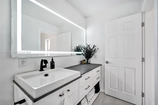 an aerial view of a house with a yard basket ball court and outdoor seating