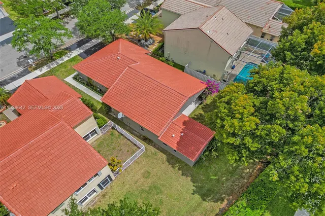 an aerial view of a house with garden space and street view