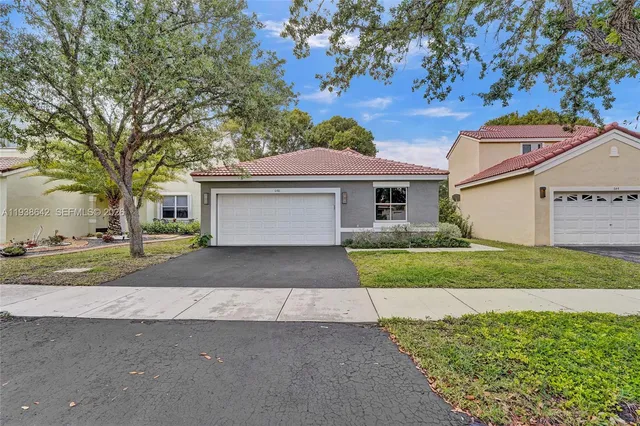 a front view of a house with a yard and garage