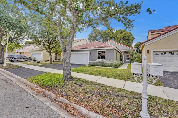 a living room with furniture a rug and a wall painting