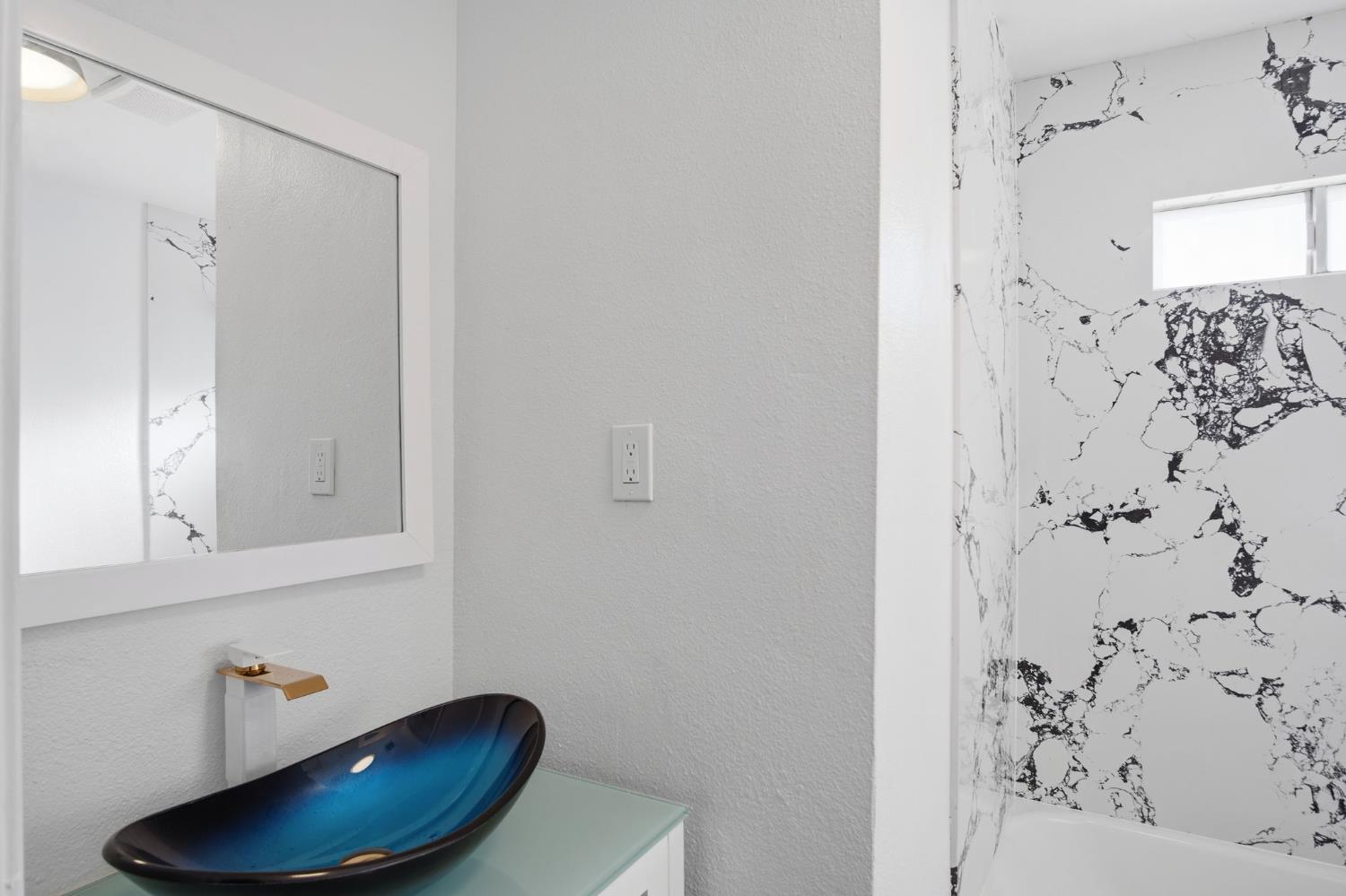 816 Dawn Drive Modesto, CA 95350 - Photo 14 of 22 a bathroom with a sink and a mirror